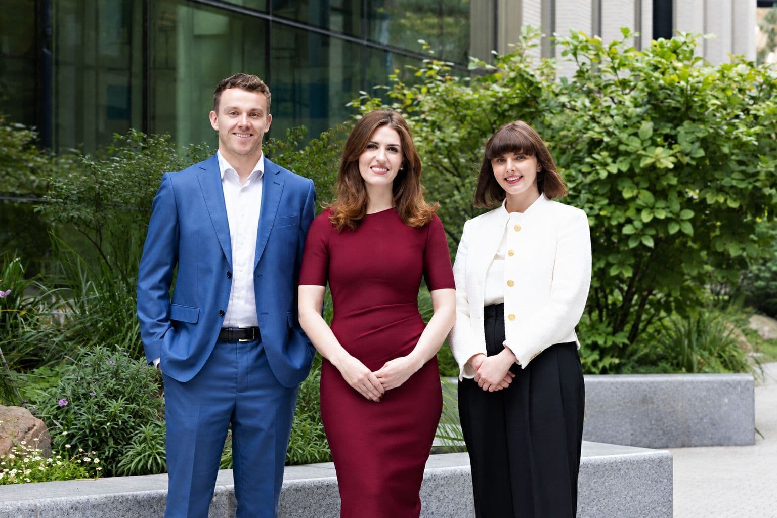 3 Newcode team members smiling outside the Irish office
